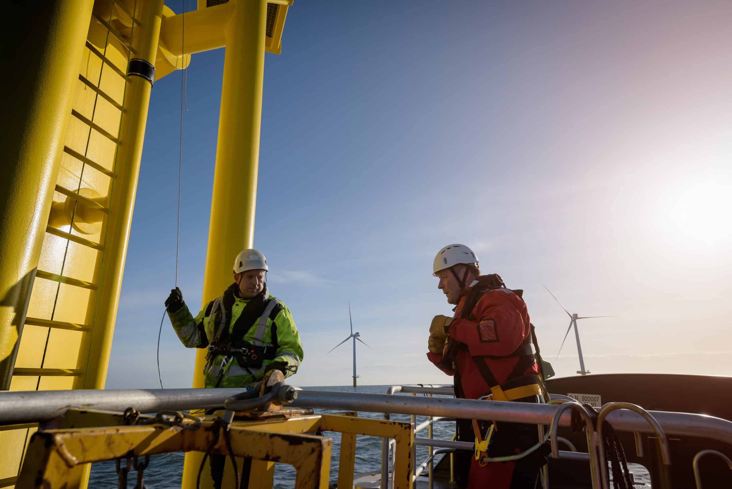 Engineers about to climb wind turbine on offshore wind farm