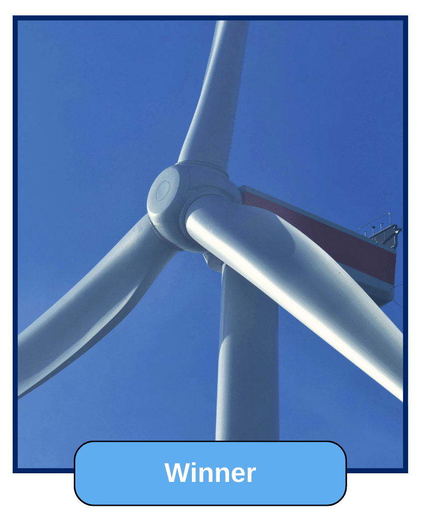 A close-up of a wind turbine’s blades and structure, highlighting clean energy technology.