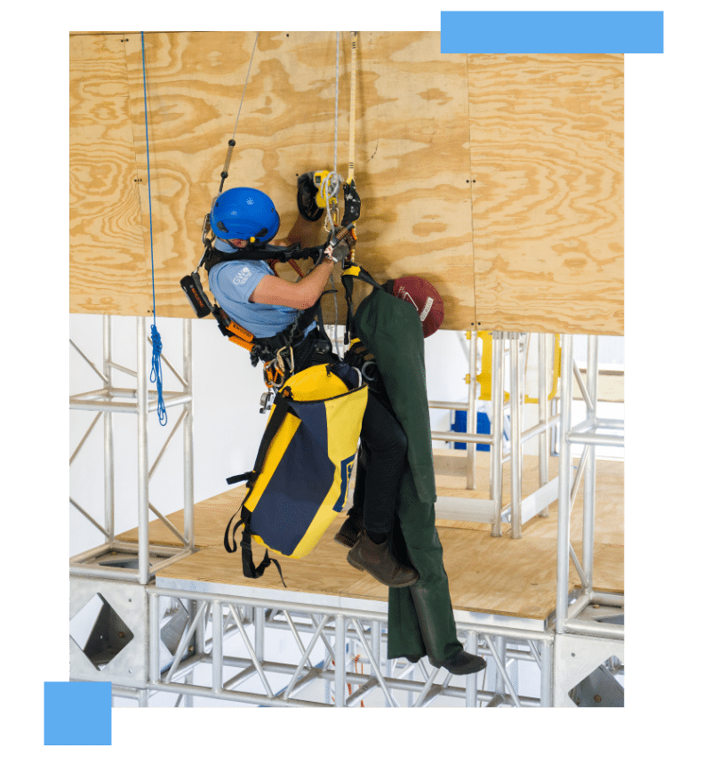 Wind turbine technician practicing GWO Certification rescue training while suspended on ropes