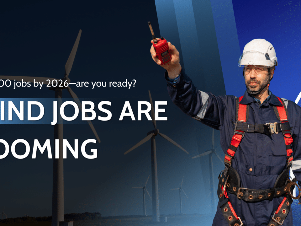 Wind technician signaling on a wind farm highlighting booming wind jobs