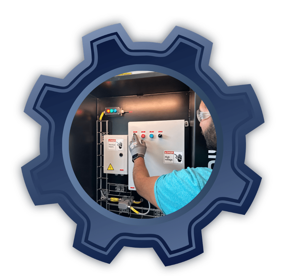 Maintenance technician in safety gloves and goggles operates an electrical control panel with red and blue push buttons inside a dark gear-shaped frame.