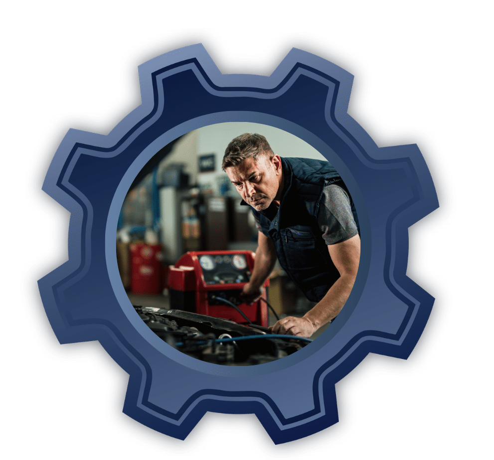 Mechanic leaning over a car engine in a workshop, framed by a blue gear graphic.